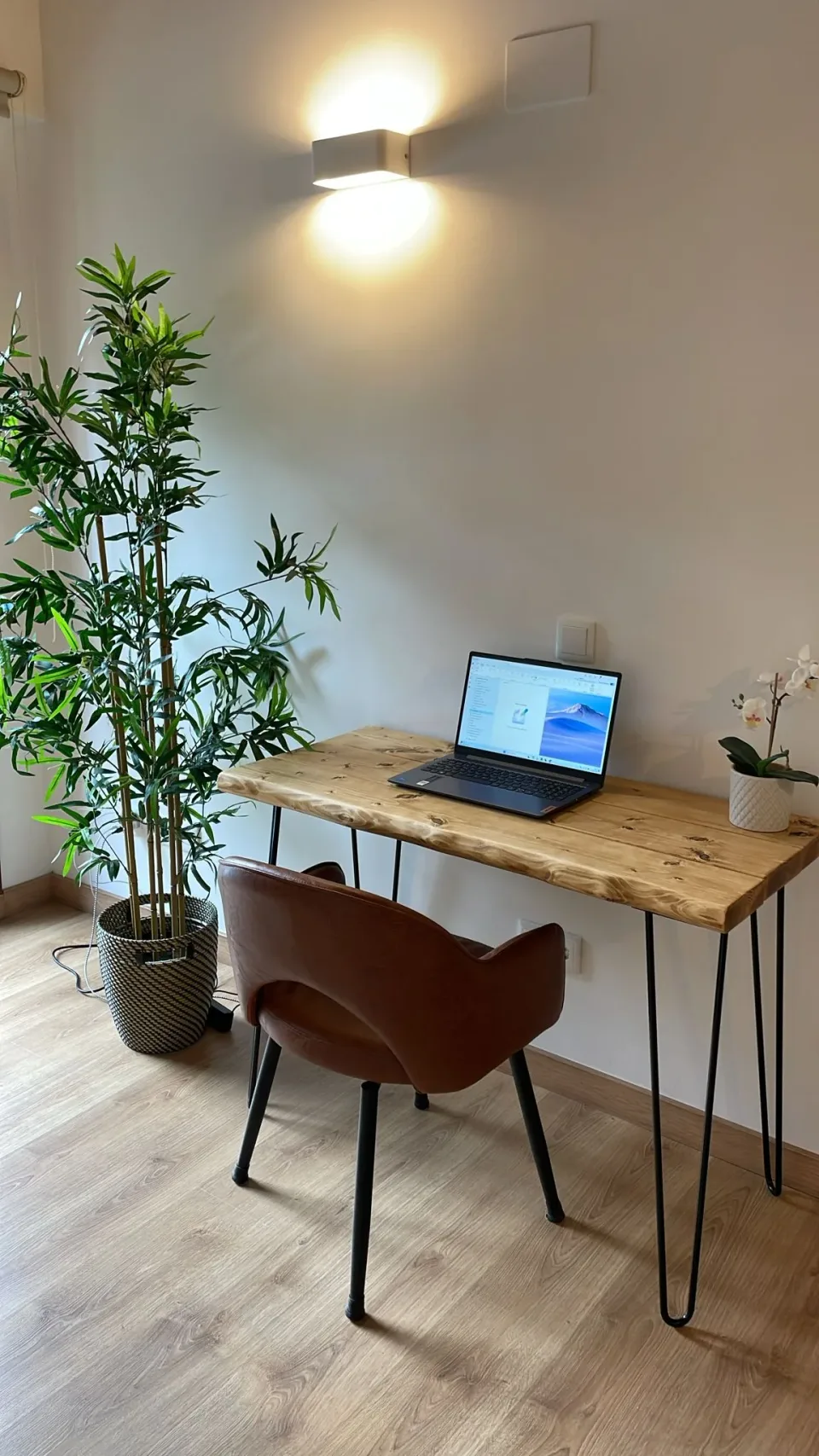 Your workspace. A wooden desk, chair and natural light for combining work with a mountain getaway.