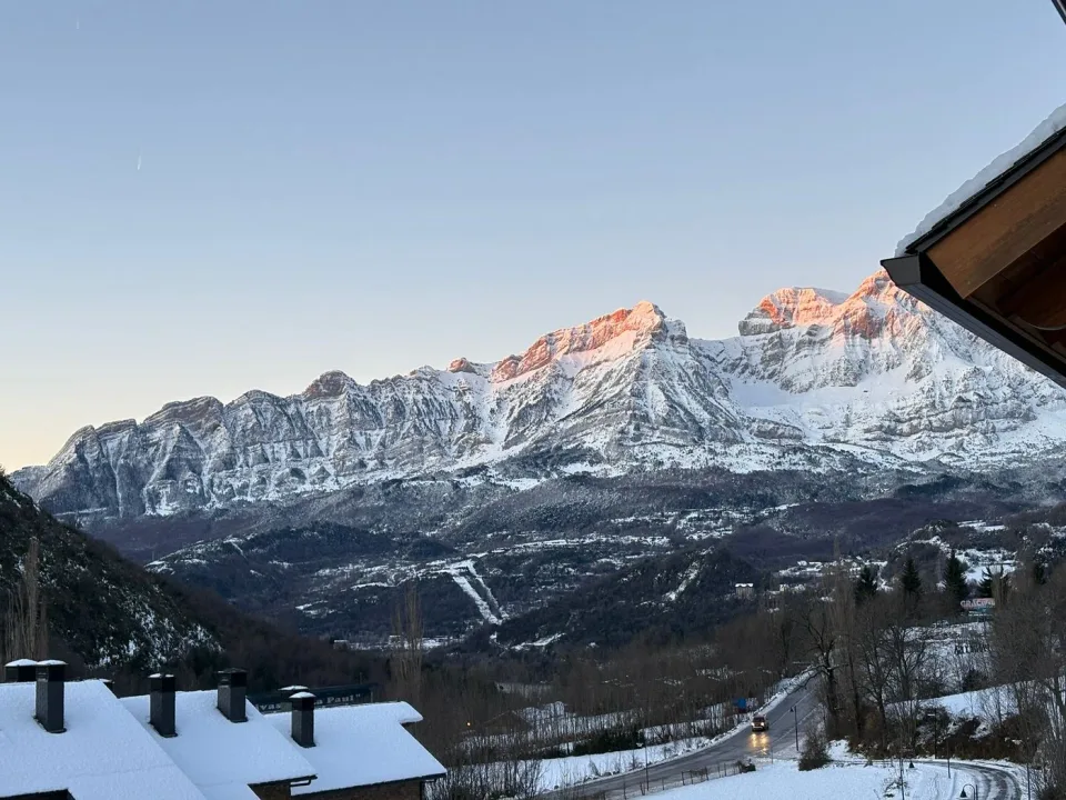 Views of the snowy Pyrenees. Mountains and Panticosa rooftops, photographed from the apartment in winter.
